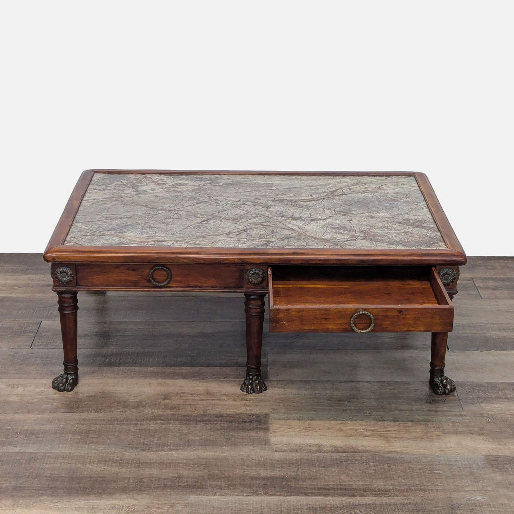 Reperch coffee table showing an open drawer, metal paw feet, and decorative hardware.