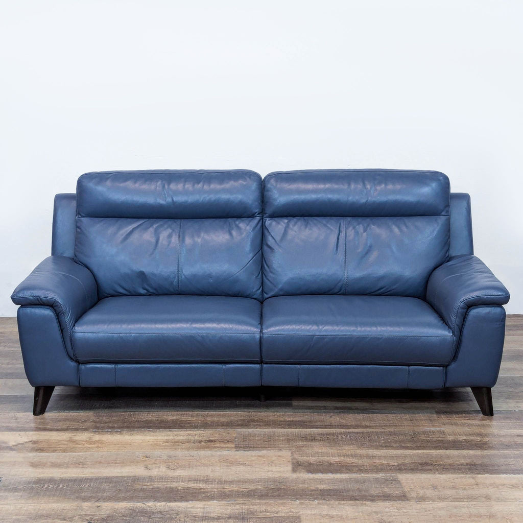 Blue leather 3-seat sofa with tapered legs and tailored stitching.