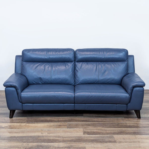 Blue leather 3-seat sofa with tapered legs and tailored stitching.
