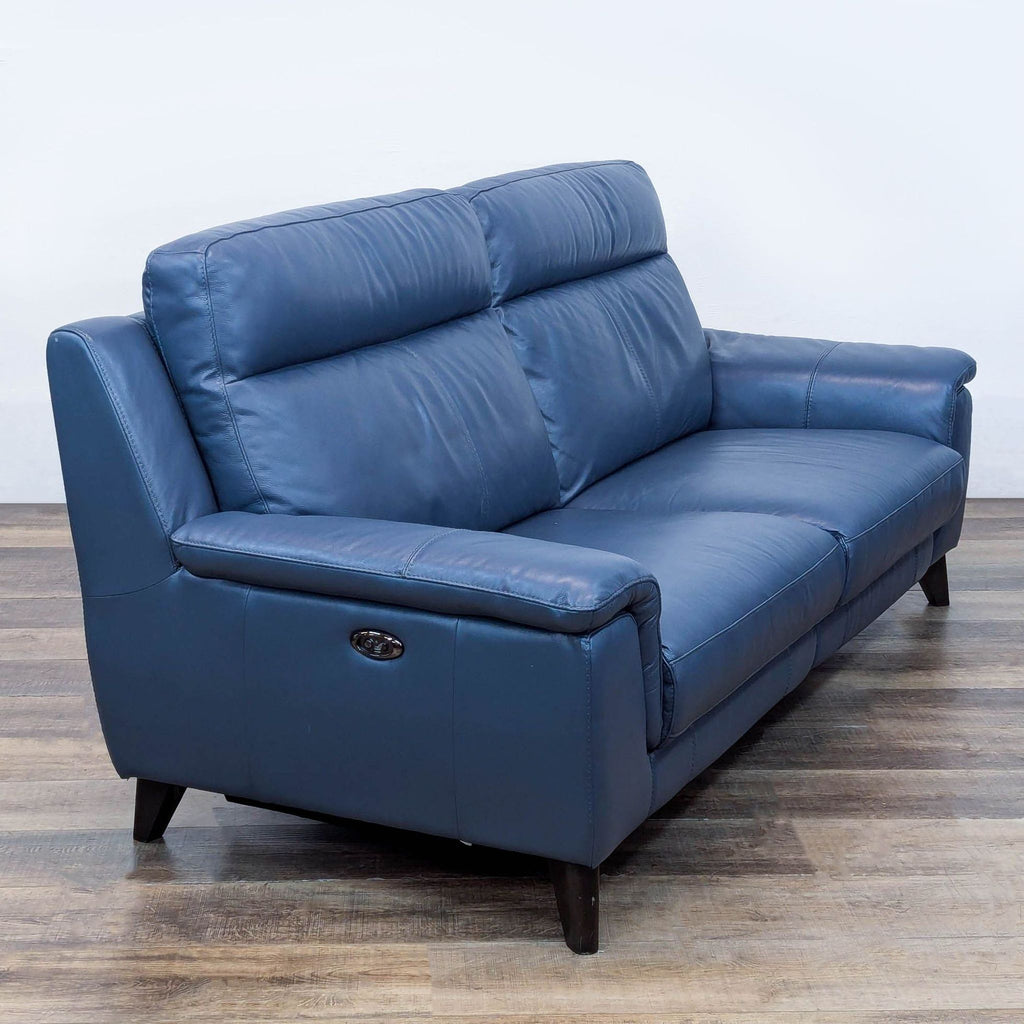 Elegant 3-seat blue sofa by Living Spaces with modern design.