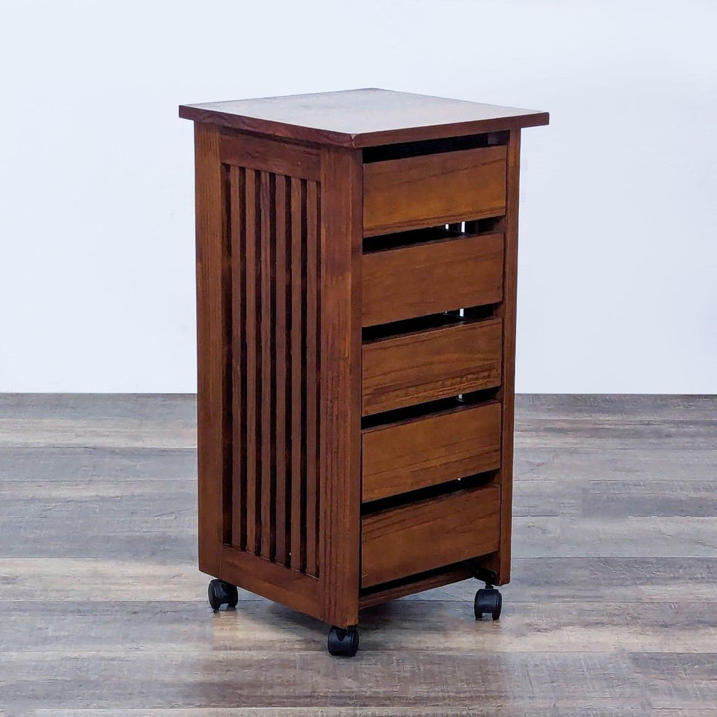 Wooden drawer unit on wheels, displaying slatted design and a compact, vertical structure.