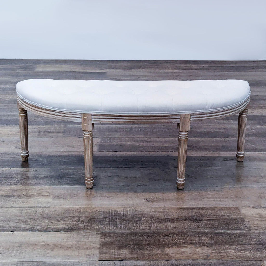 Half-moon bench with linen upholstery and fluted wooden legs, featuring vertical grooves.