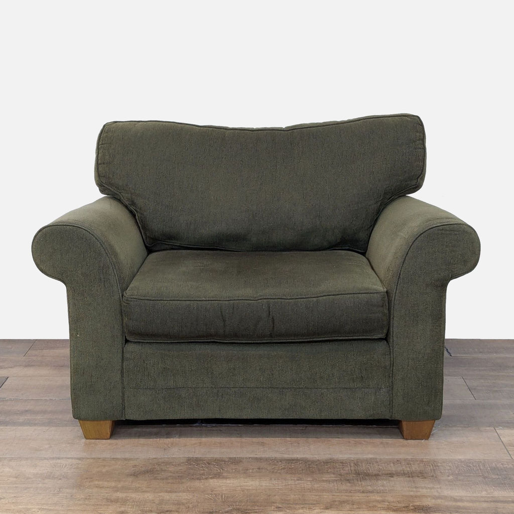 Oversized lounge chair with rolled arms, tapered wood feet, and plush cushions by Bauhaus.