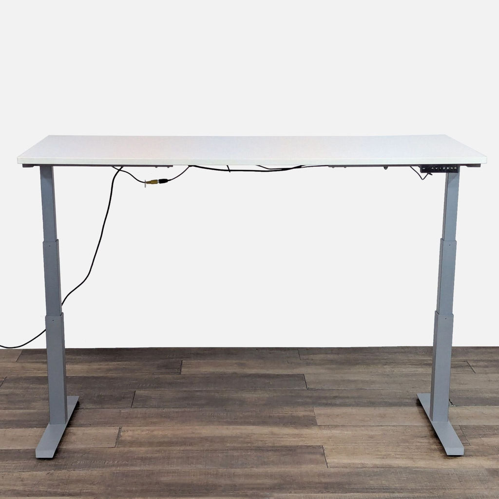 Height-adjustable desk by AMQ with memory presets. 