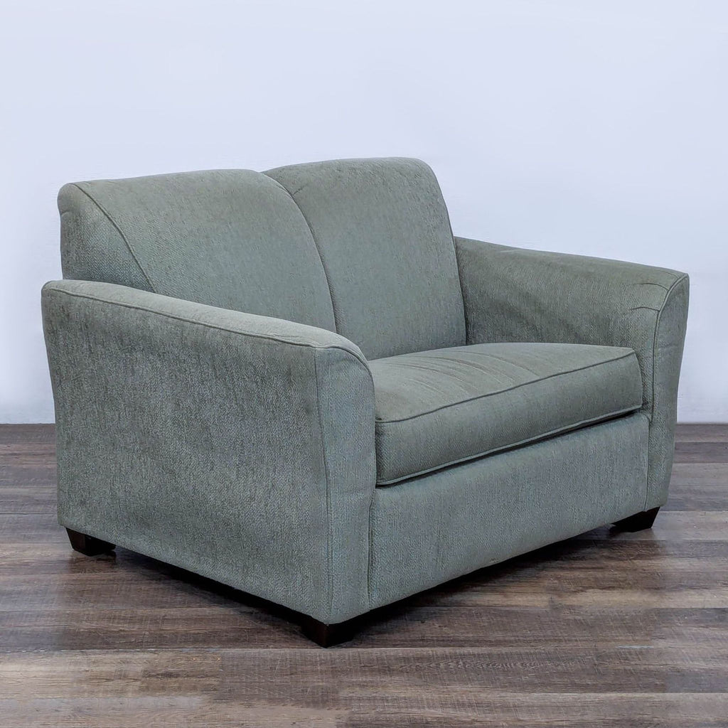 Side view of a compact sleeper sofa with a clean front rail design.