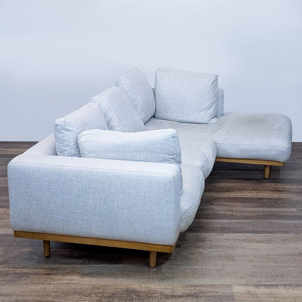 Modern sectional sofa featuring an airy platform, deep seating, and toss back cushions for cozy relaxation.