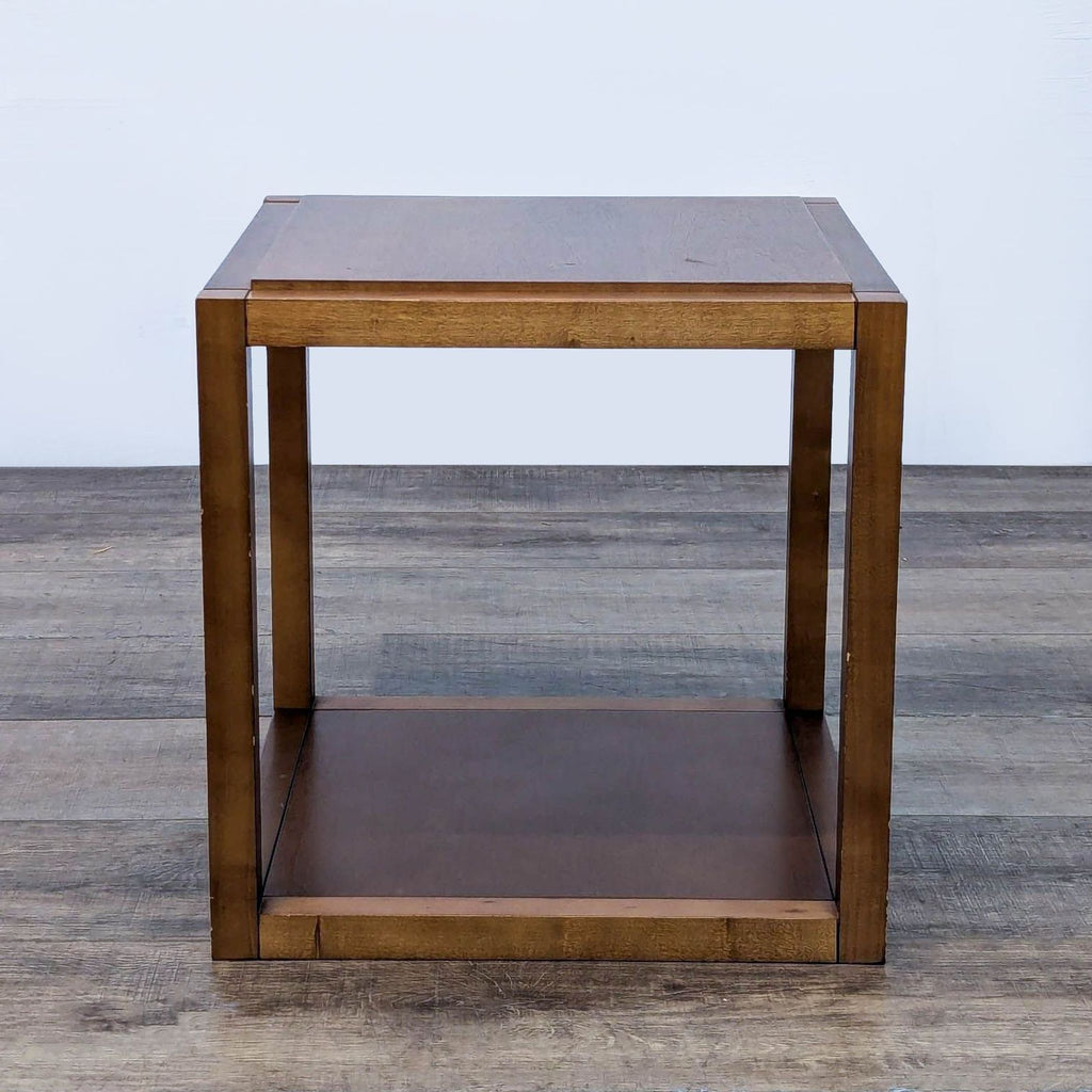 Square-shaped Reperch end table with a wood finish and sturdy frame.