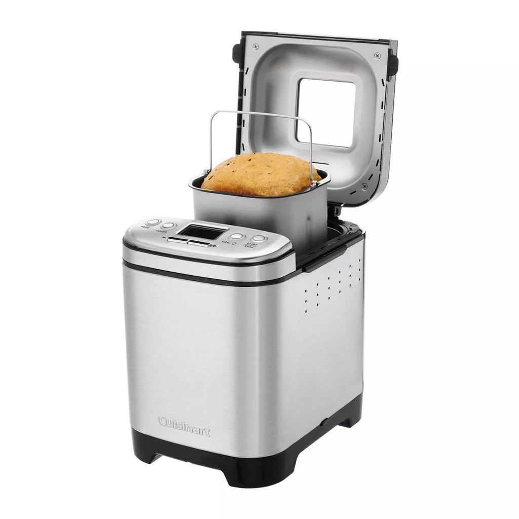 Open Cuisinart bread maker revealing freshly baked loaf.
