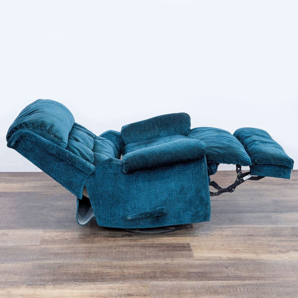 Side view of a blue manual recliner, fully extended.