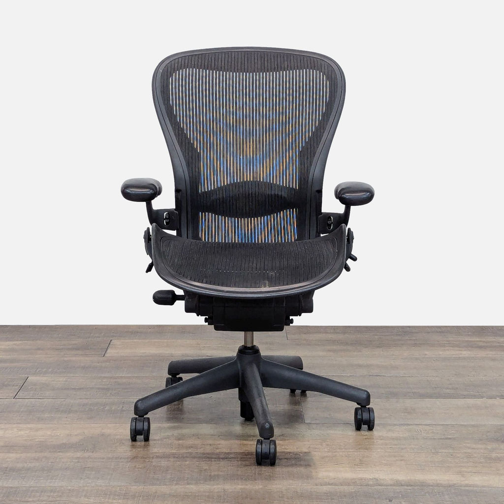 Herman Miller Aeron Chair with adjustable arms and breathable back.