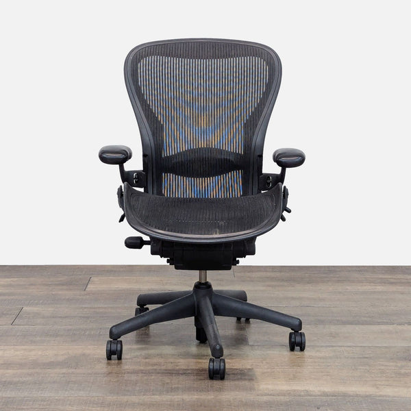 Herman Miller Aeron Chair with adjustable arms and breathable back.
