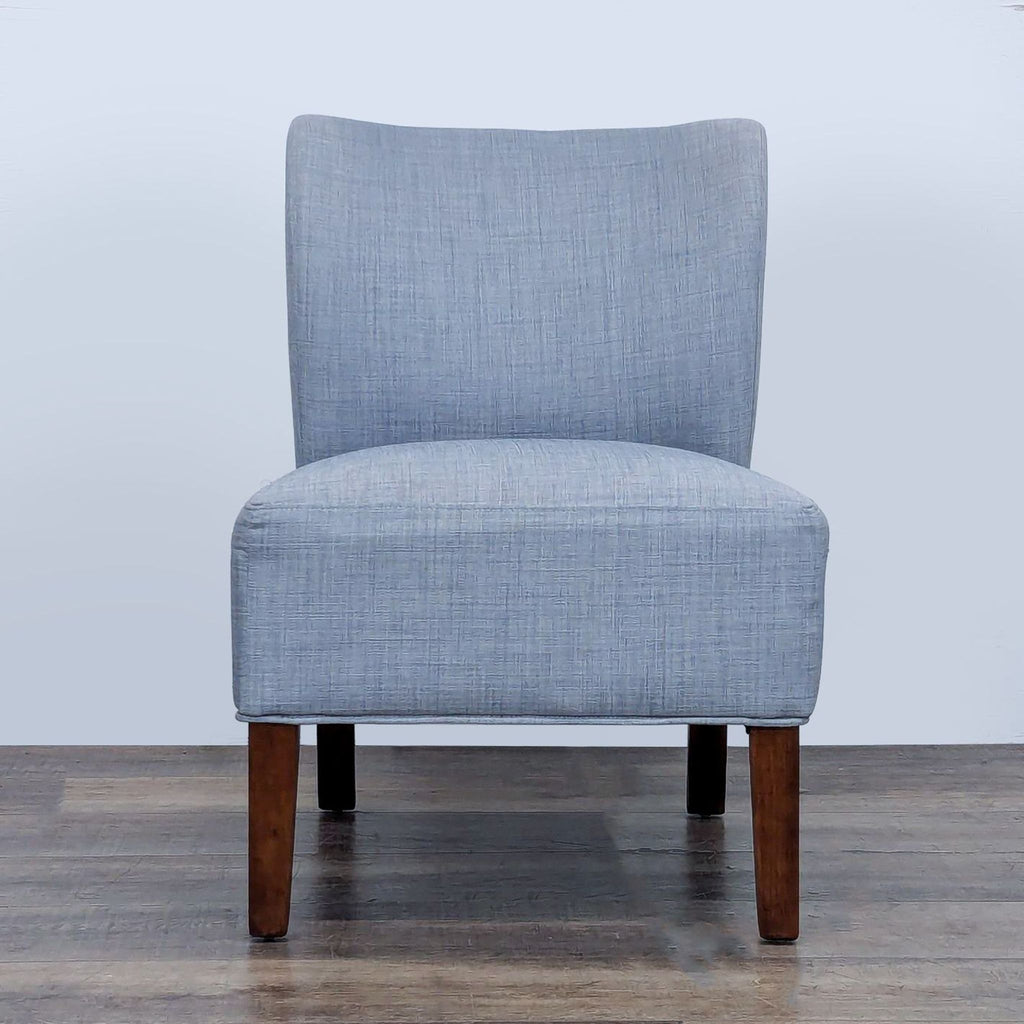 Front view of a slipper chair with wood legs and gray linen upholstery.