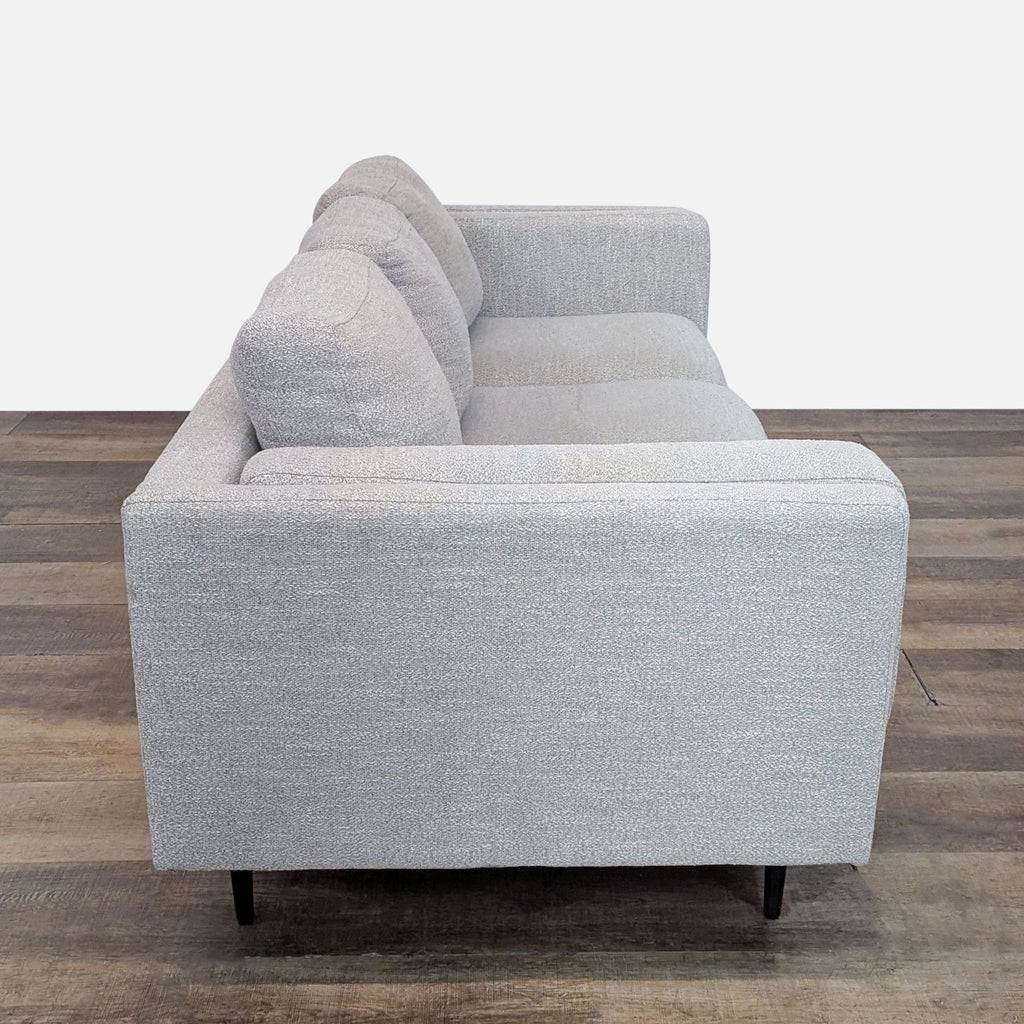 Side view of a 3-seat light gray sofa, highlighting its track arms and sleek design.