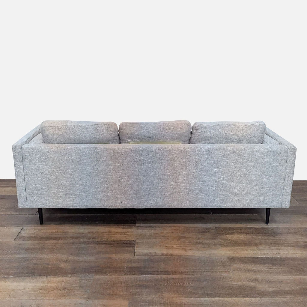 Back view of a 3-seat light gray sofa, showcasing its clean lines and tapered legs.