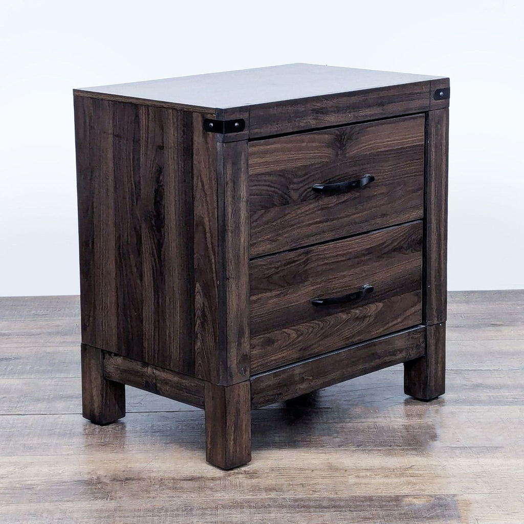 Angled view of wooden nightstand, highlighting its compact design and metal corner details.