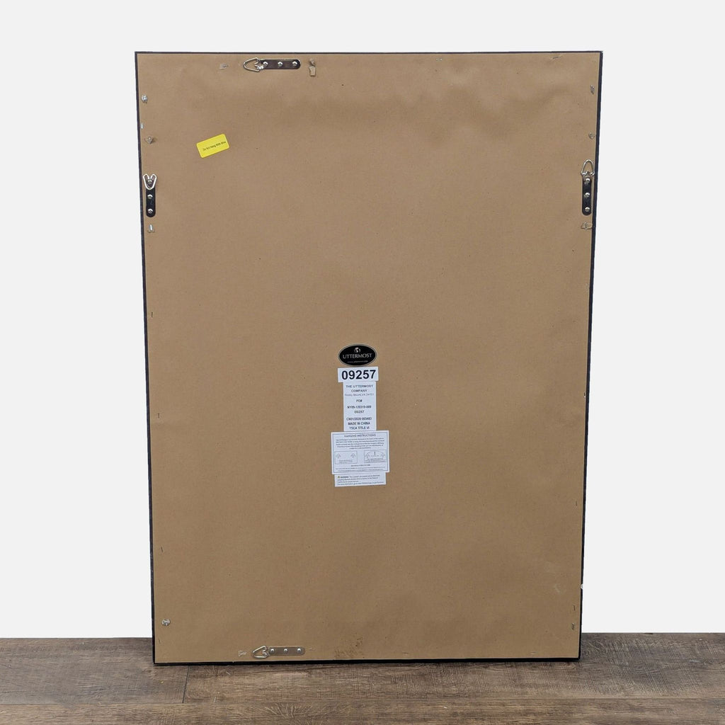 2. Back view of a large rectangular mirror showing mounting hooks and a label.