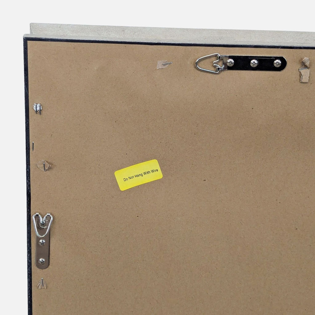 3. Close-up of mirror's back corner with hanging instructions and metal hardware.
