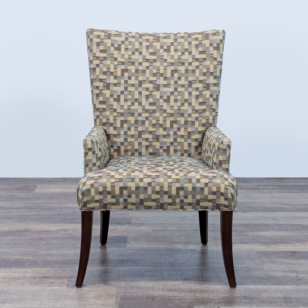 Mosaic-patterned accent chair with high back and armrests on dark wood legs.