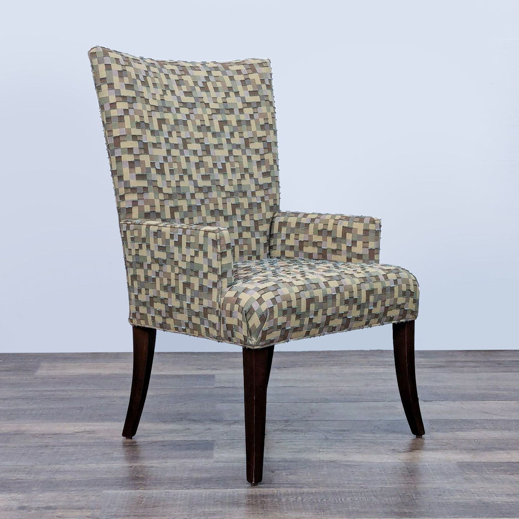 Side view of high-back lounge chair with mosaic fabric and dark wood legs.