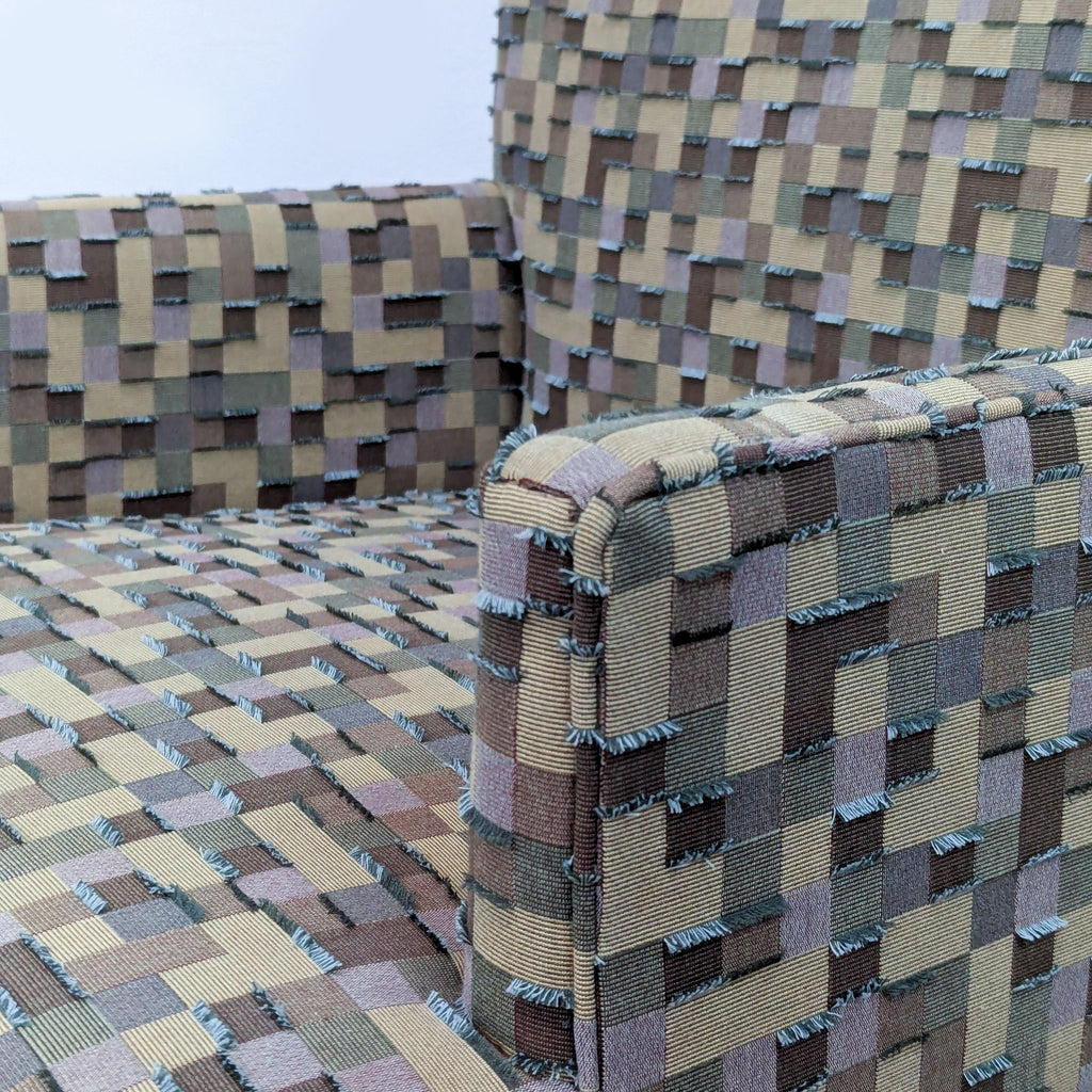 Close-up of multi-toned mosaic fabric on chair, showing texture and detail.