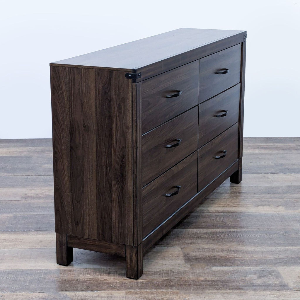 Side perspective of a brown Living Spaces dresser with closed drawers and a simple design.