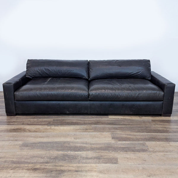 Three-seater leather sofa with a sturdy wooden frame and sleek design.