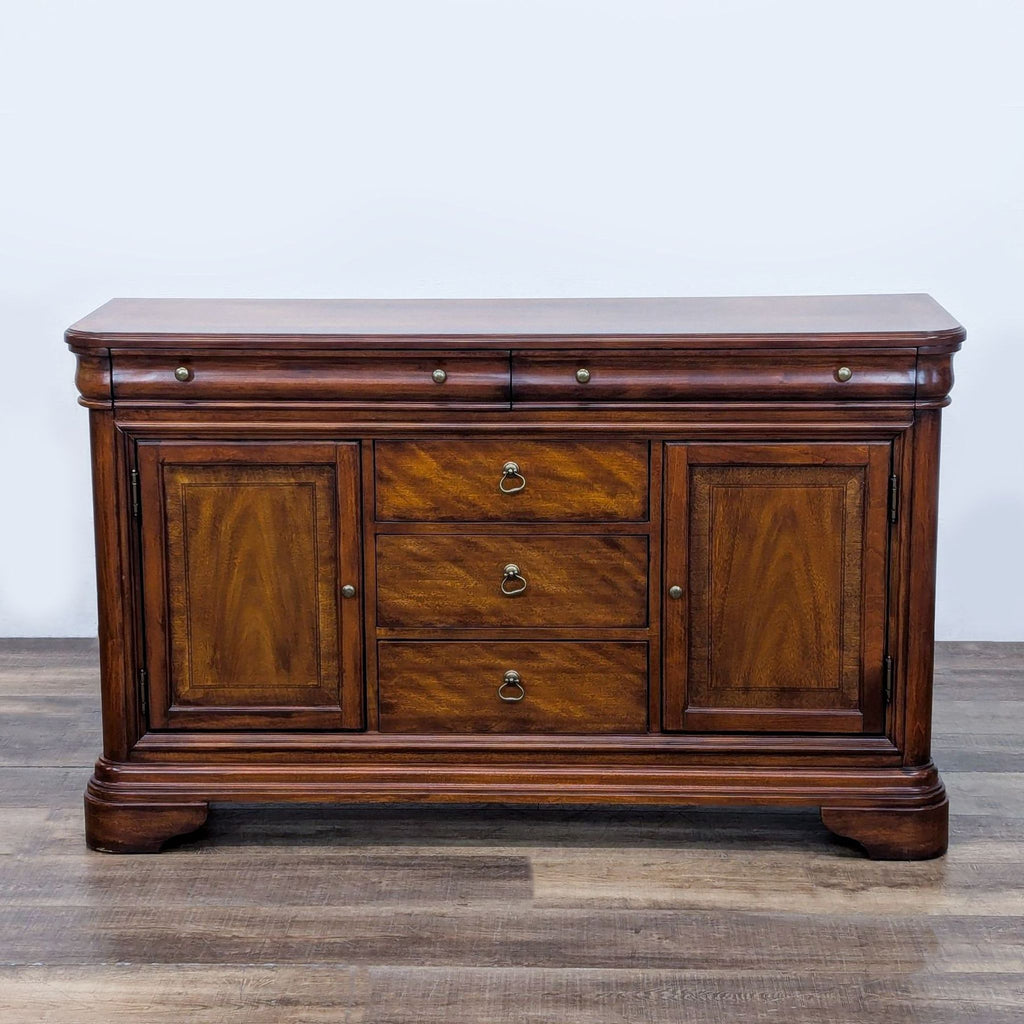 Reperch sideboard with wood finish, featuring three central drawers and two side cabinets.
