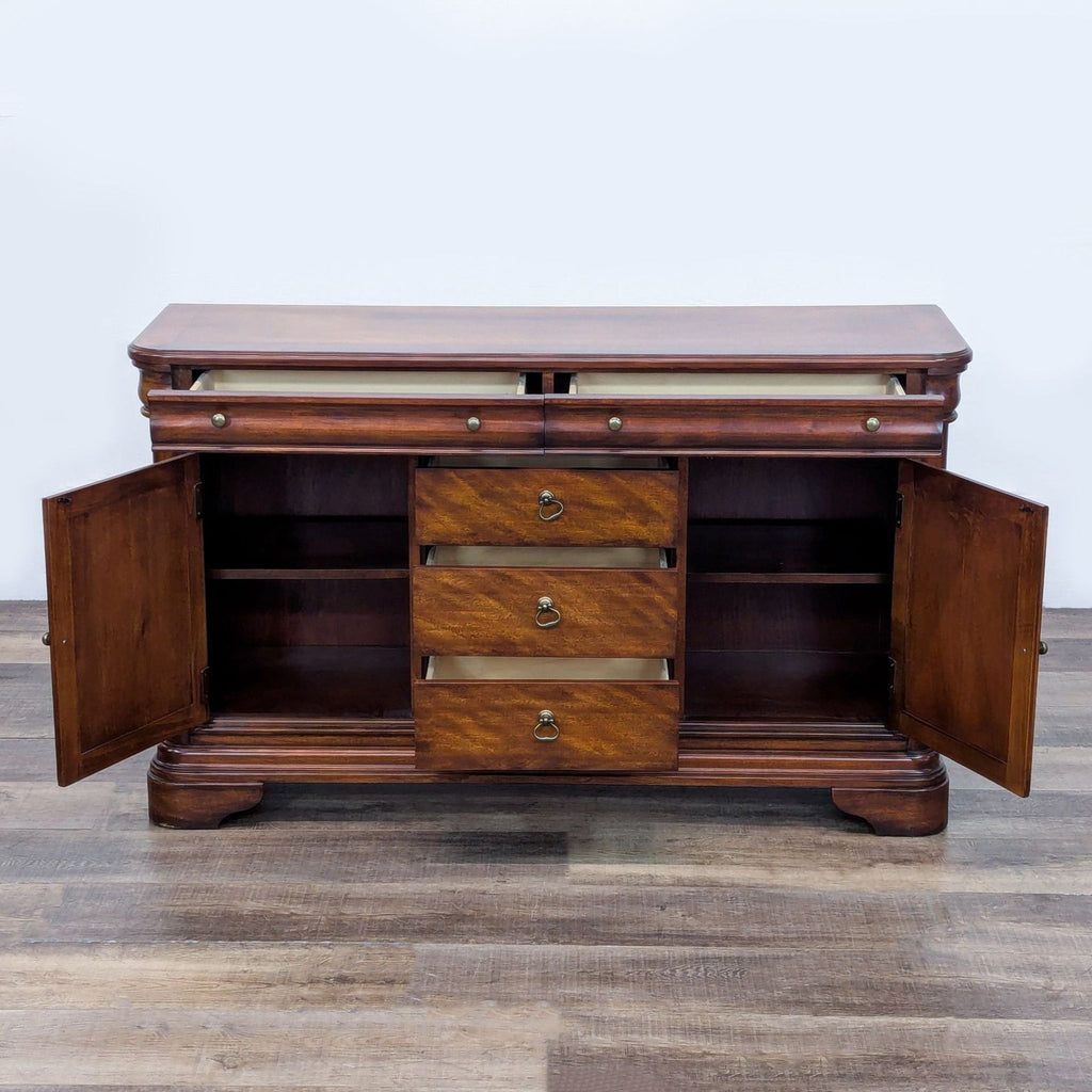 Open Reperch sideboard showcasing spacious interior storage with three drawers and two shelves.