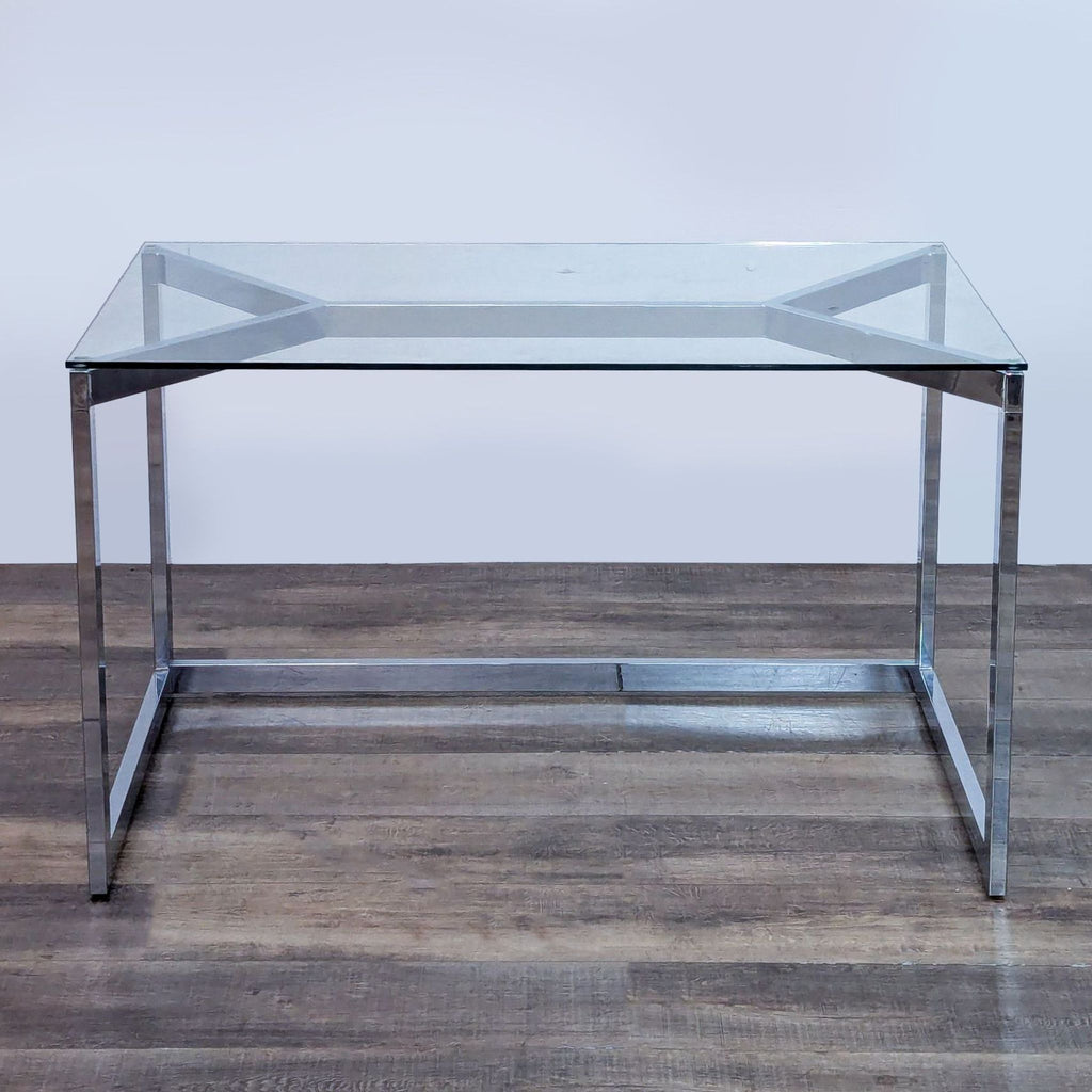 Sleek desk with chrome metal frame and glass top from CB2.