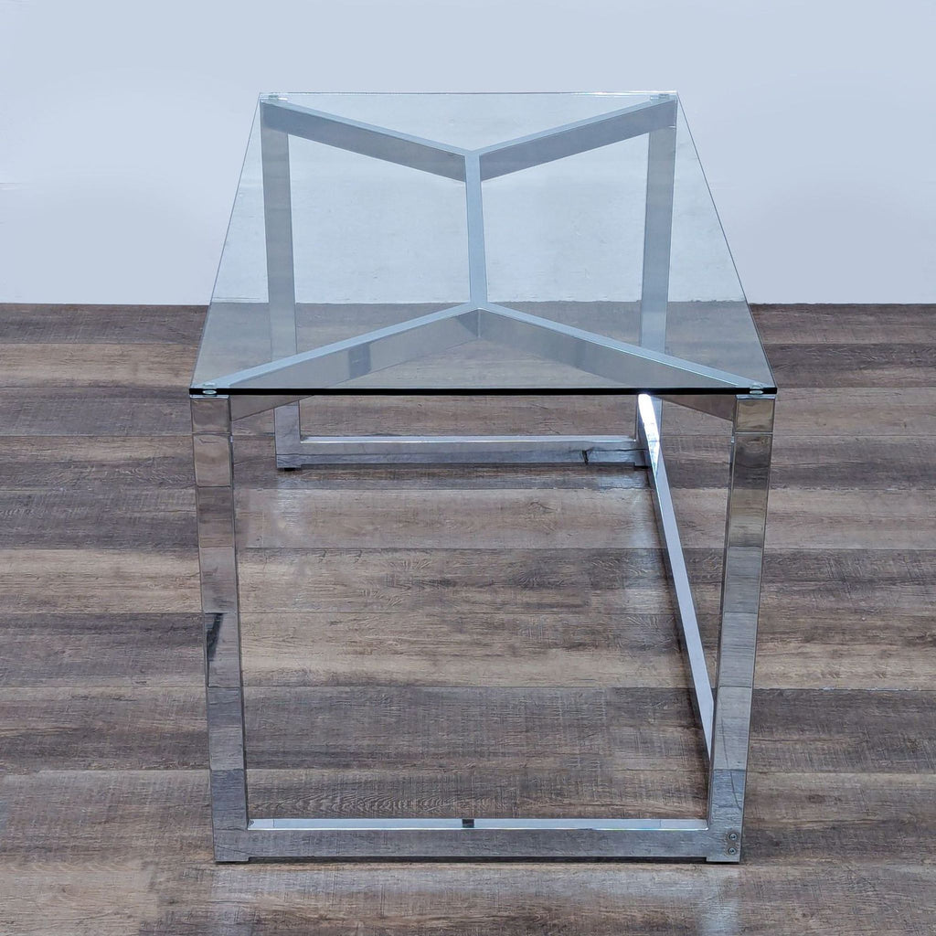 Modern CB2 desk featuring chrome frame and glass surface.