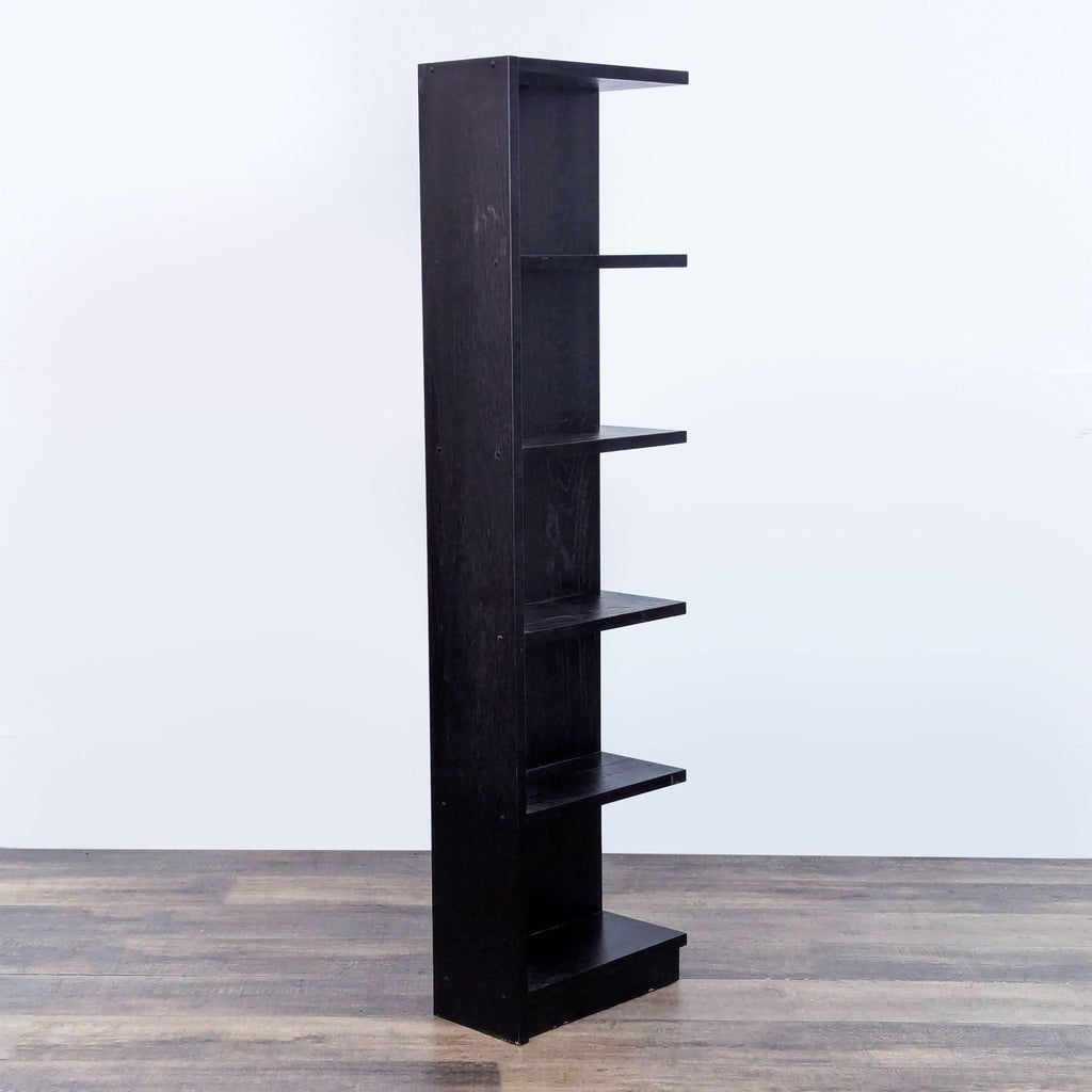 Side view of a black bookshelf with five shelves and a sleek design.