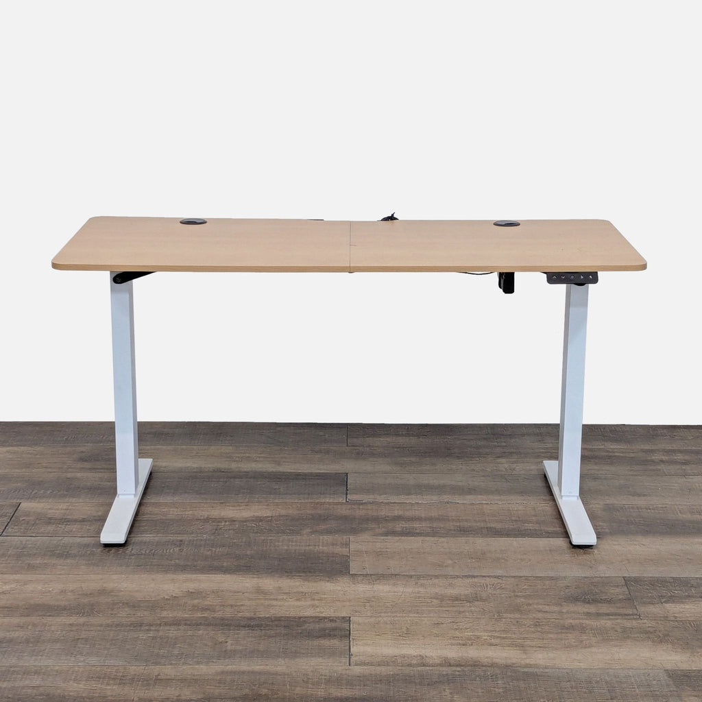 Electric desk with metal T-frame legs, oak laminate top.