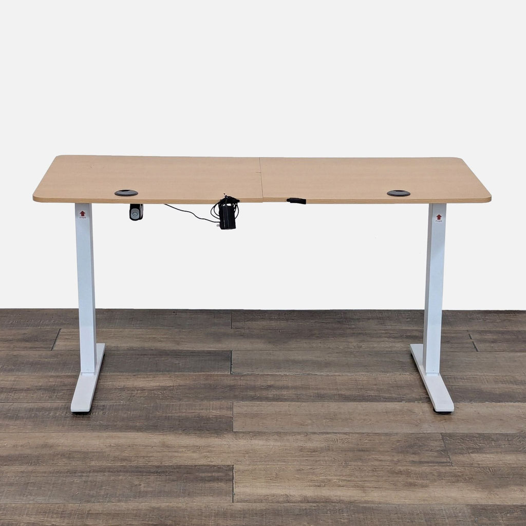 Adjustable desk with oak finish and white T-frame legs.