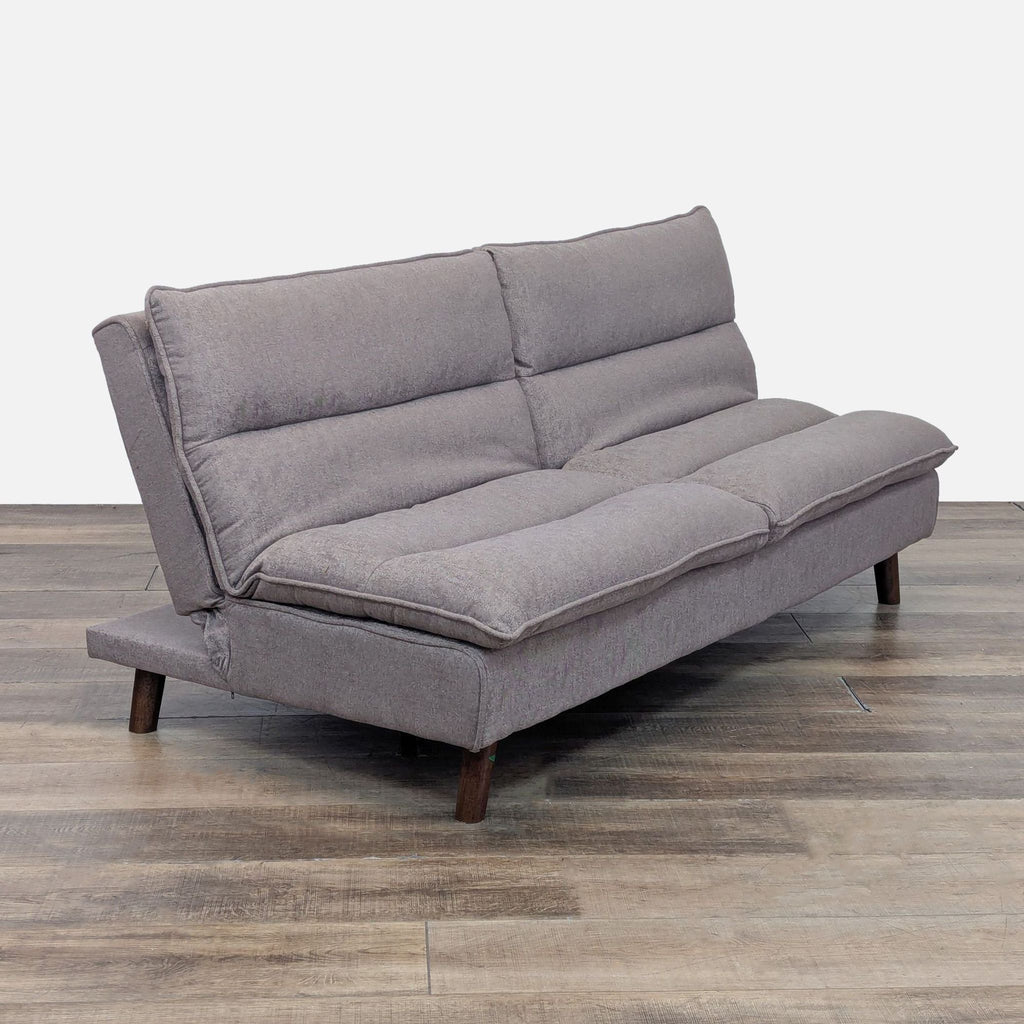 Side view of gray Reperch Sleeper Sofa with channel tufting and wooden legs.