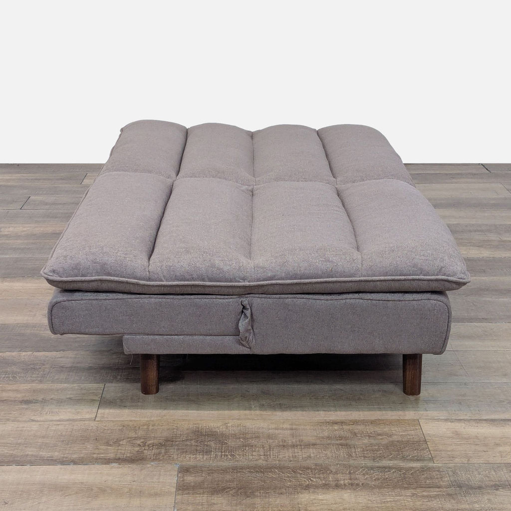 Gray Reperch Sleeper Sofa unfolded into a bed with tufted upholstery and wooden legs.  