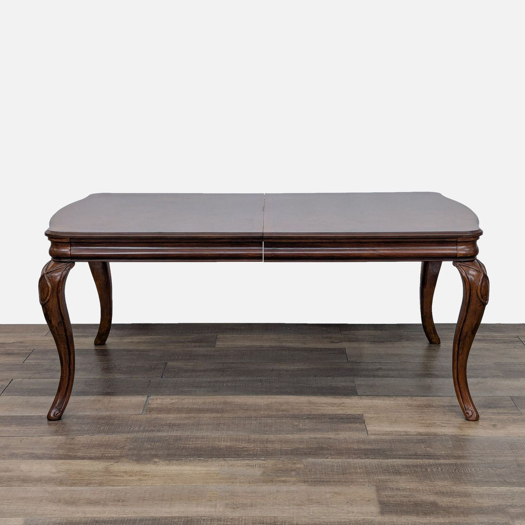 Reperch dining table with cabriole legs, expanding from 72 to 96 inches using inserts.