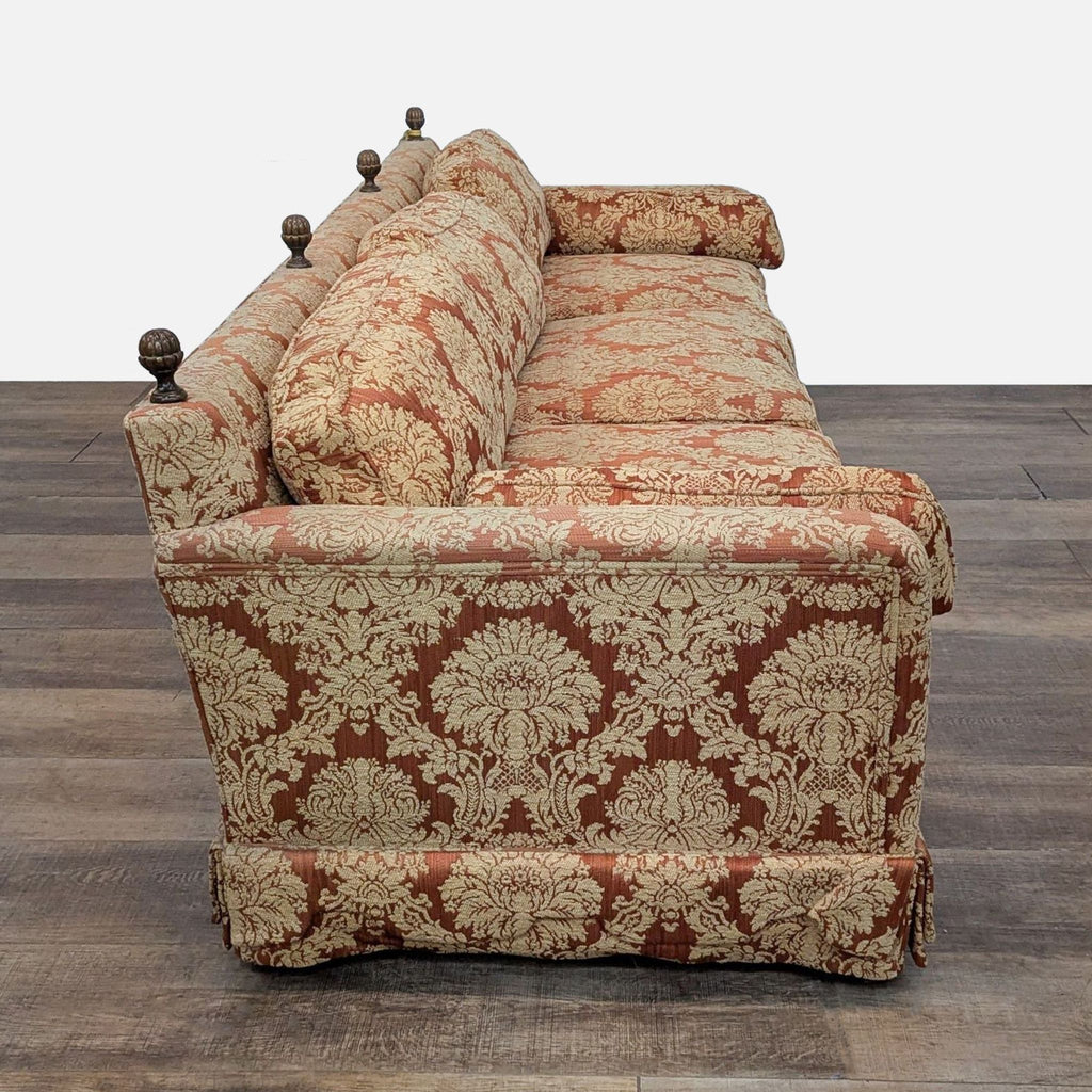 Henredon sofa featuring classic damask pattern and wooden spindle accents on the back.