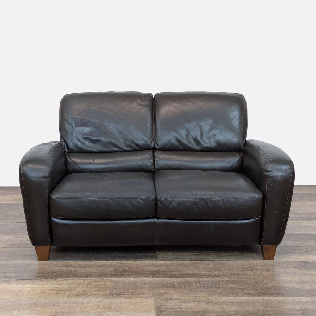 Front view of Italsofa loveseat with leather upholstery and wood feet.