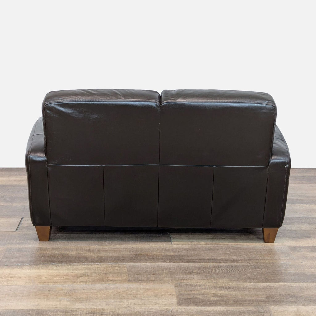 Back view of Italsofa loveseat featuring sleek leather and sturdy wood feet.