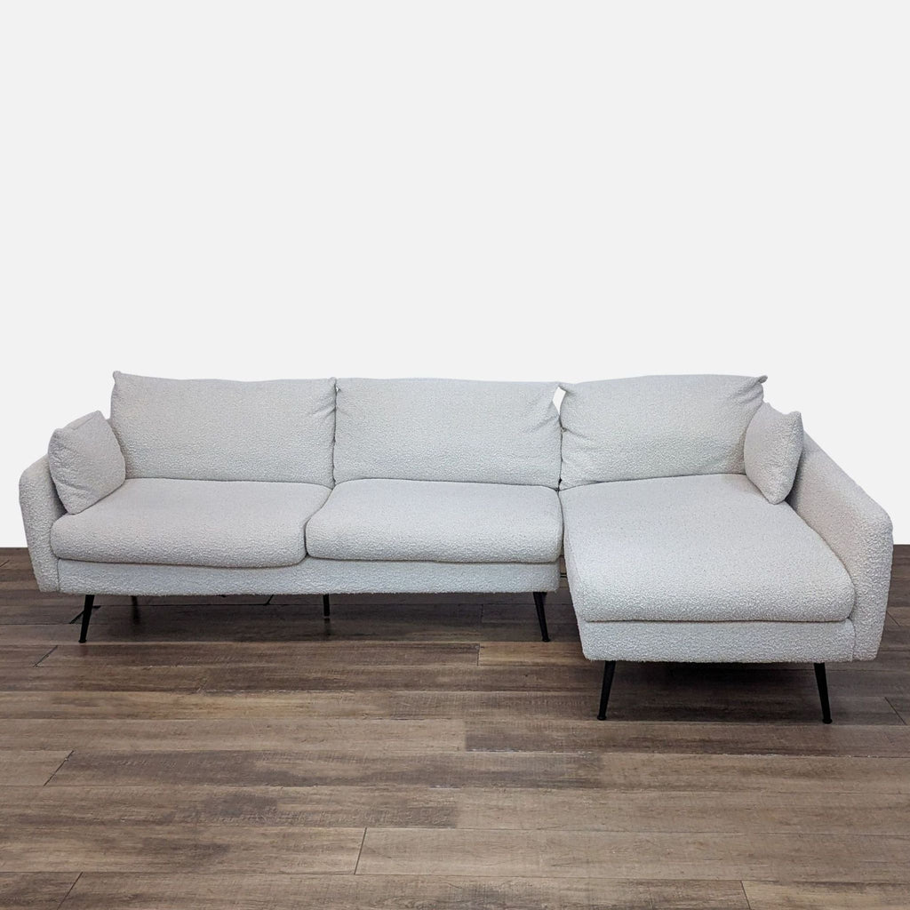 Albany Park sectional with bouclé fabric and black metal legs.
