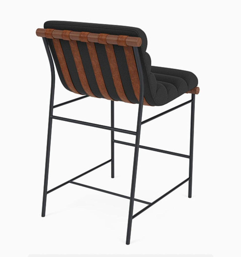 Back view of charcoal channel-tufted stool featuring walnut and leather detailing.