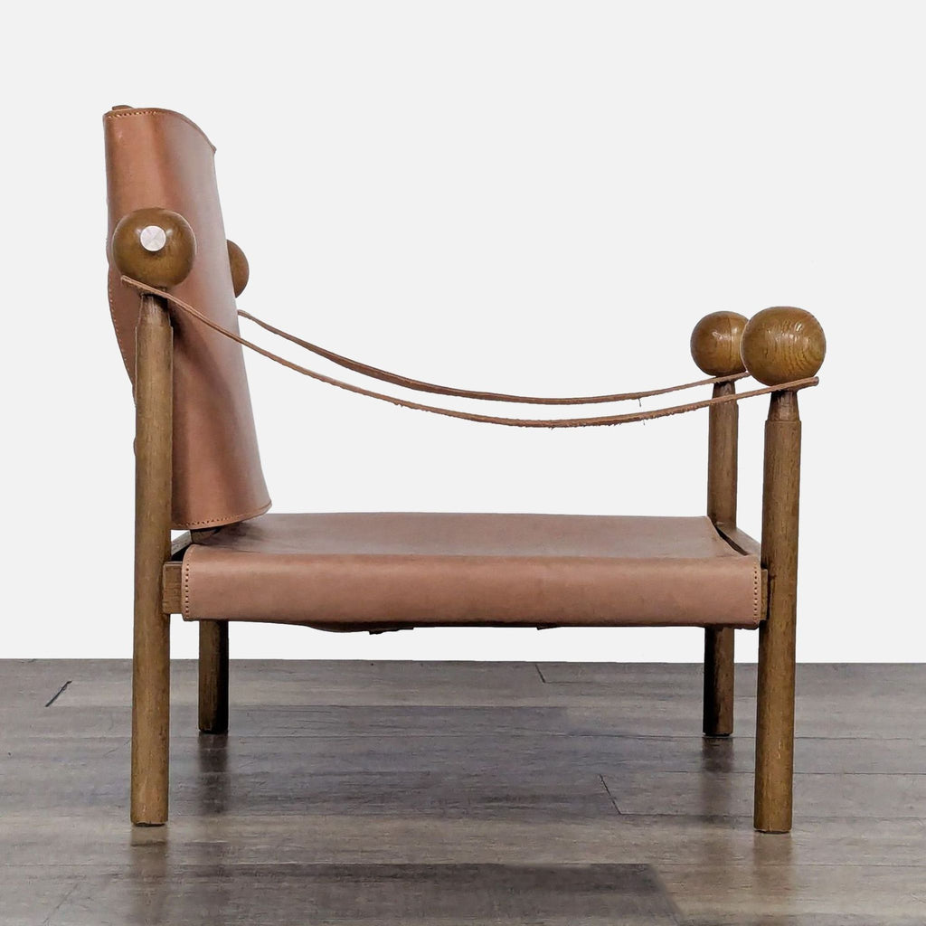 Side profile of a Safari chair showing genuine leather straps and solid oak wood construction.