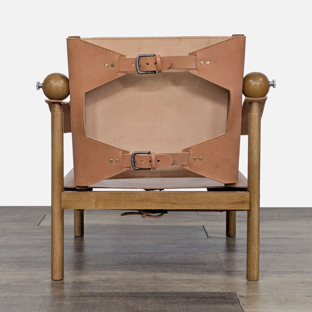 Back of Safari chair featuring buckled leather straps and a sturdy oak frame in Wildberry.