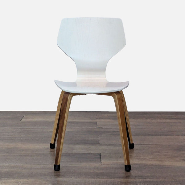 1. White molded plywood Room & Board dining chair with tapered wood legs, viewed from the front.
