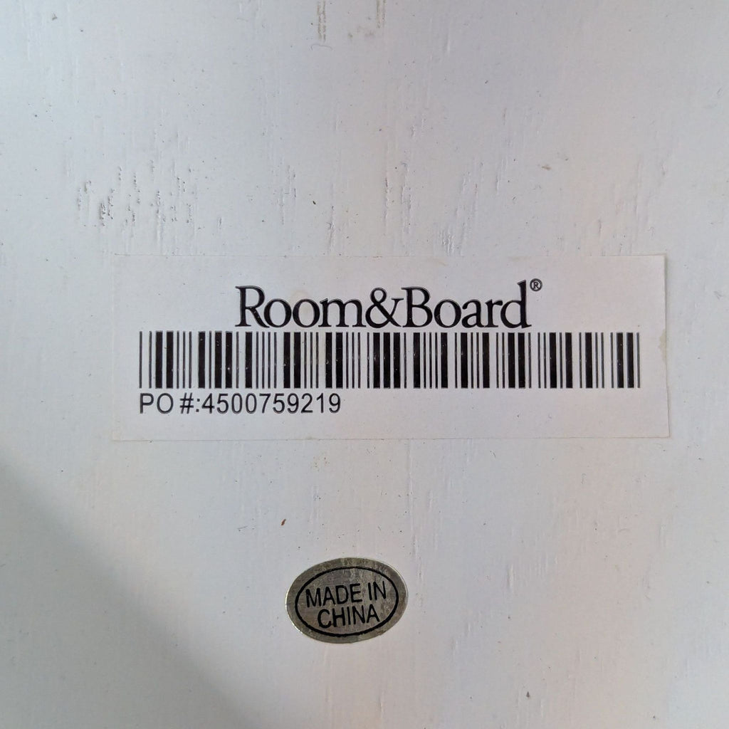 2. Room & Board brand label with barcode and "Made in China" sticker on the underside of the chair.