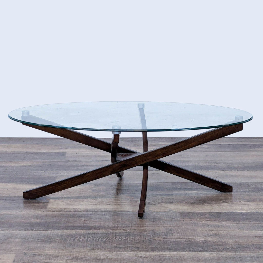 Reperch coffee table featuring a glass top and vintage starburst espresso base.