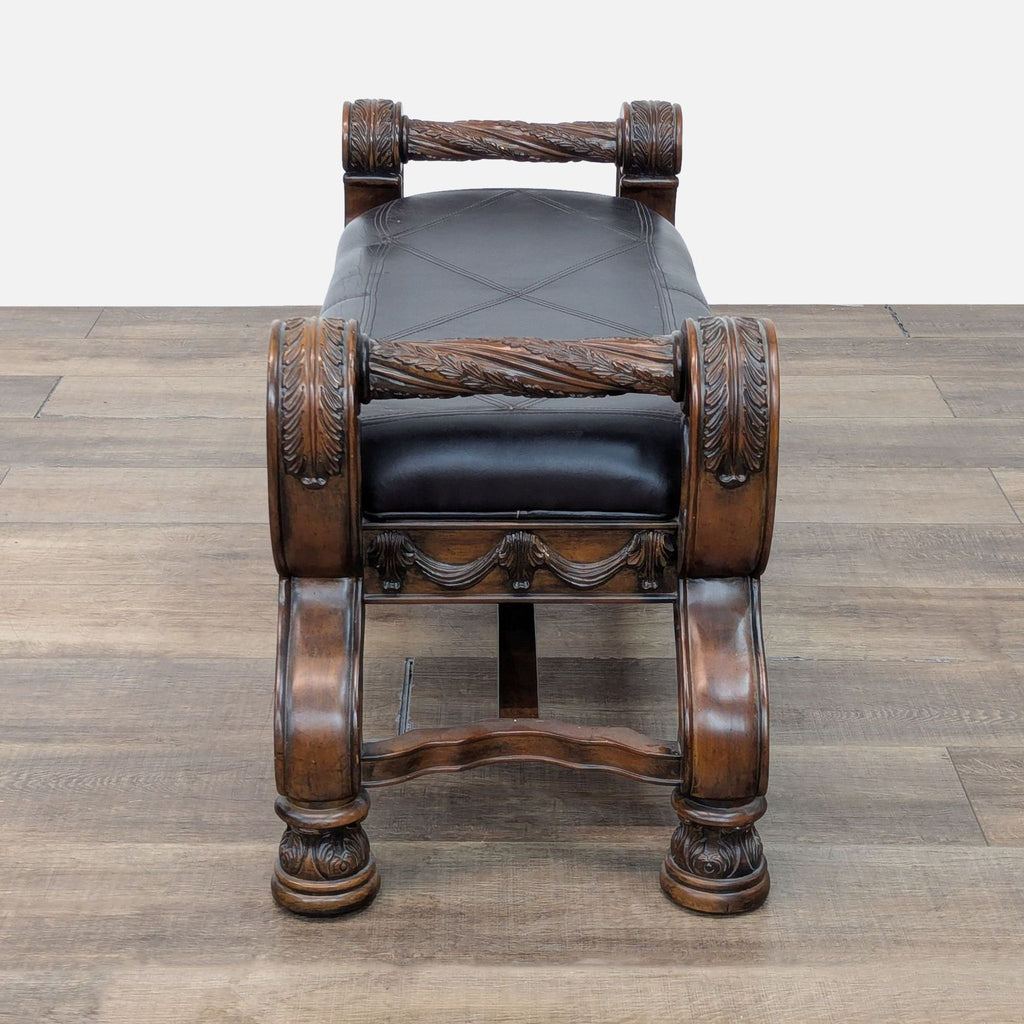 Classic bench by Ashley Furniture featuring detailed carvings, cushioned vinyl seat, and ornate scrollwork.