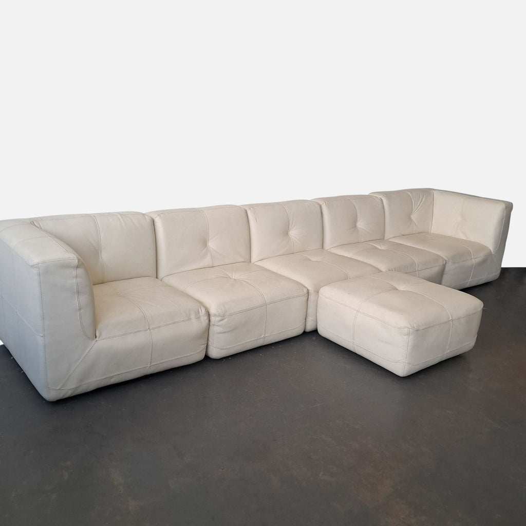 2. Chateau D’ax modular sectional in white leather with stitched piping, featuring multiple sections and an ottoman.  