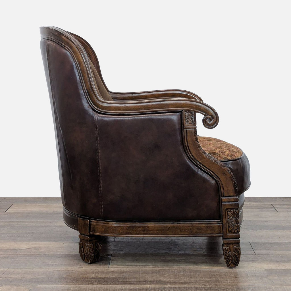 Side view of a lounge chair with detailed wood carvings and a mix of leather and tapestry materials.