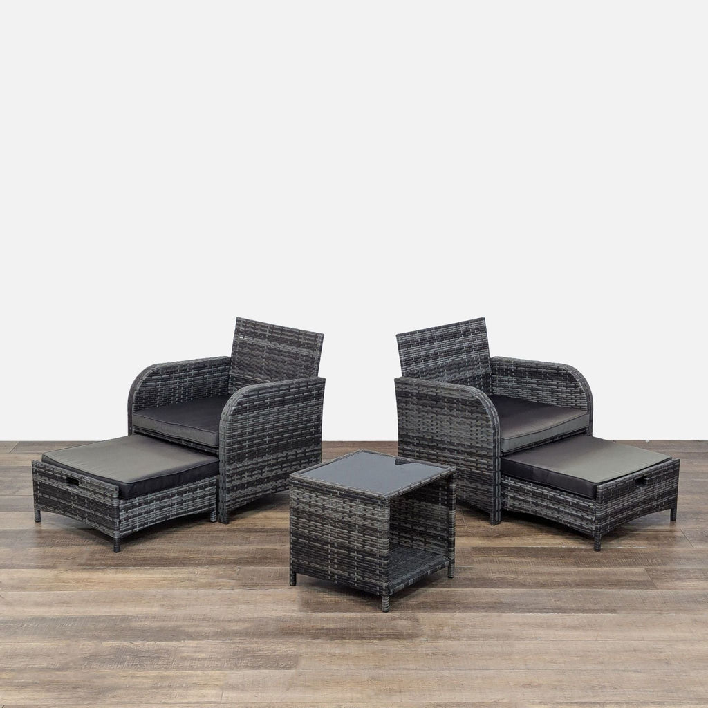 Two chairs with pull-out ottomans and a matching side table.